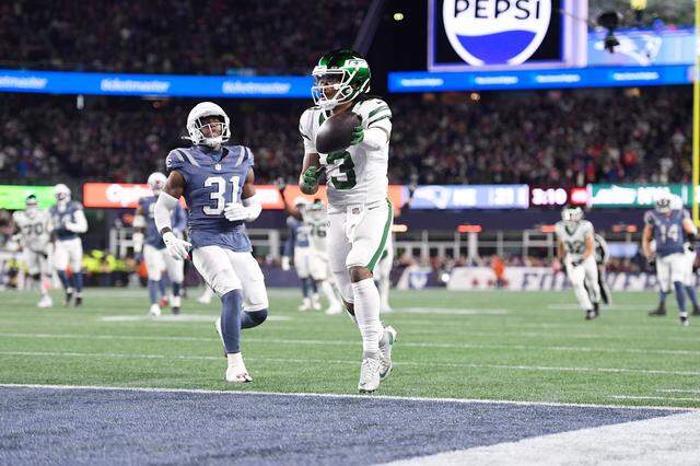 John Metchie III, pictured here as a member of the New York Jets, scores a touchdown against the New England Patriots during the second half of a 2025 game at Gillette Stadium in Foxborough, Massachusetts.