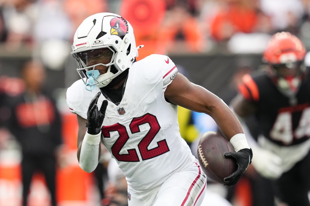 Michael Carter #22 of the Arizona Cardinals runs with the ball in the first quarter against the Cincinnati Bengals at Paycor Stadium on December 28, 2025 in Cincinnati, Ohio.