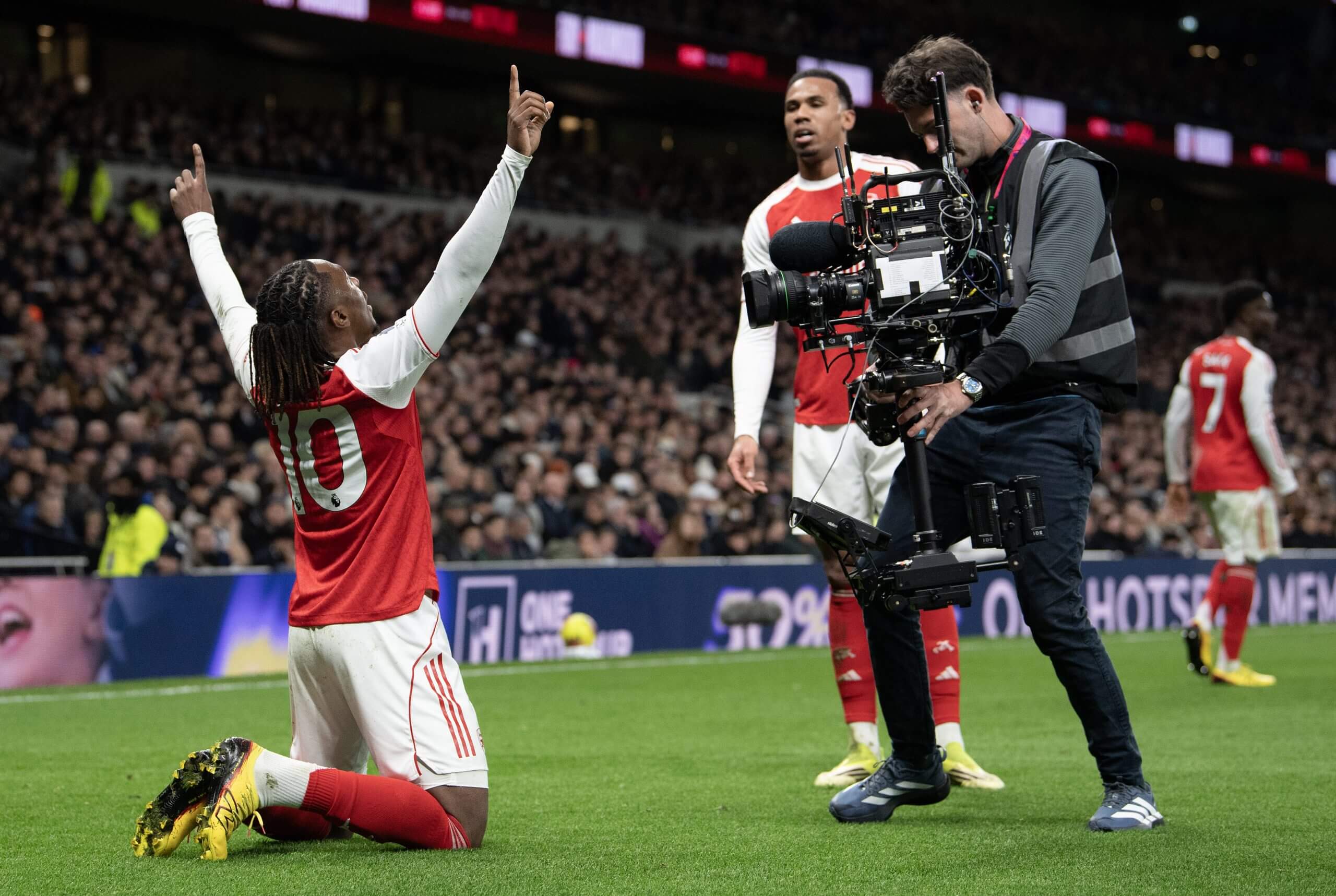 A broadcast camera films Arsenal's Eberechi Eze celebrating a goal