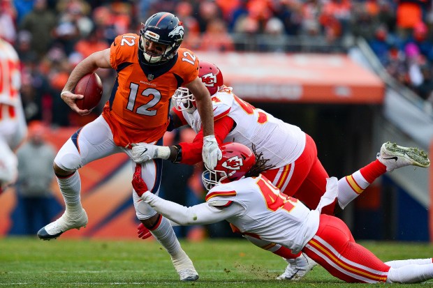 Quarterback Paxton Lynch of the Denver Broncos is tackled by inside linebacker Terrance Smith #48 and defensive tackle Jarvis Jenkins #94 of the Kansas City Chiefs scrambles against the Kansas City Chiefs in the second quarter of a game at Sports Authority Field at Mile High on December 31, 2017 in Denver, Colorado. (Photo by Dustin Bradford/Getty Images)