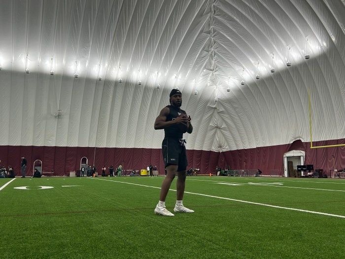 North Carolina Central running back Chris Mosley warms up by catching and throwing passes ahead of position drills at the HBCU Showcase in Ashburn, Va.