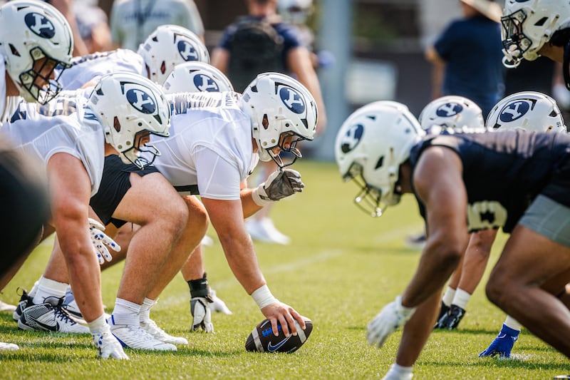 BYU offensive and defensive lines wait for the snap during the opening day of fall camp, July 30, 2025, in Provo, Utah.