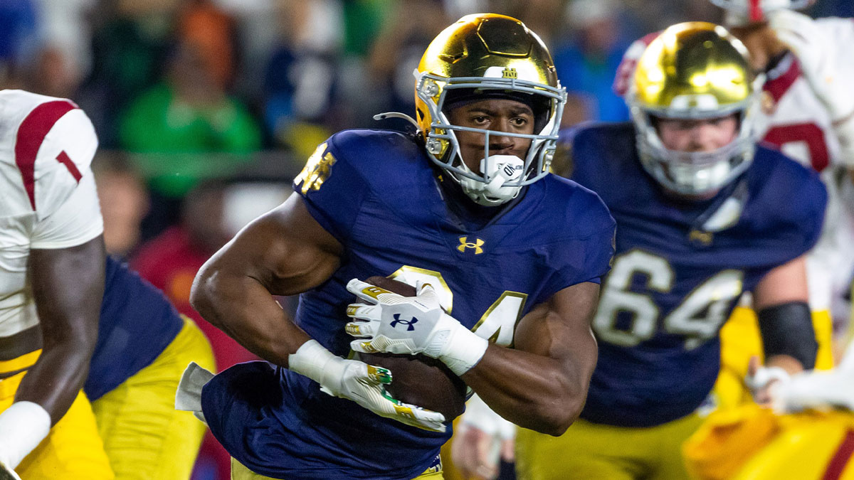 Notre Dame Fighting Irish running back Jadarian Price (24) runs the ball against the Southern California Trojans during the first half at Notre Dame Stadium.