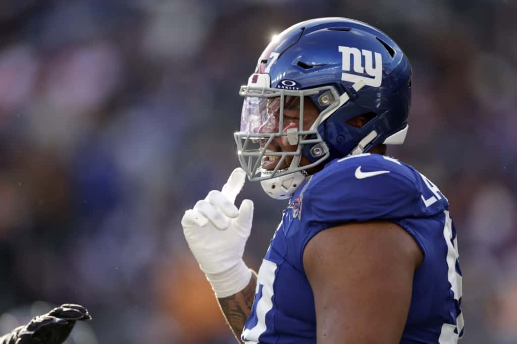 Close-up action photo of Dexter Lawrence in a New York Giants helmet and visor during an NFL game.