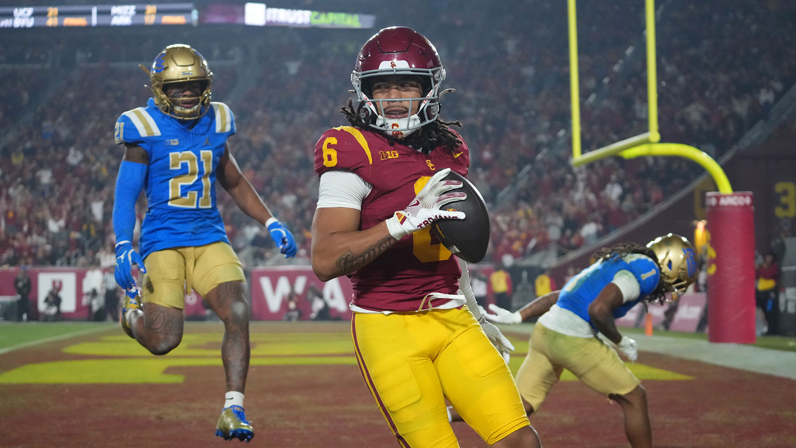 Southern California Trojans wide receiver Makai Lemon (6) catches a 32-yard touchdown pass against UCLA Bruins defensive back Kanye Clark (1) in the second half at United Airlines Field at Los Angeles Memorial Coliseum.