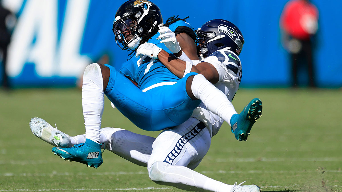 Caption: Jacksonville Jaguars wide receiver Brian Thomas Jr. (7) is tackled by Seattle Seahawks safety Nick Emmanwori (3) during the fourth quarter of an NFL football matchup, Sunday, Oct. 12, 2025, at EverBank Stadium in Jacksonville, Fla. The Seahawks defeated the Jaguars 20-12.