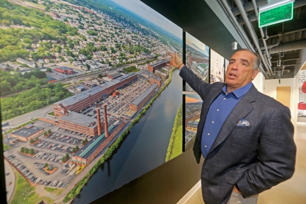 Sal Lupoli's Riverwalk complex in a mural inside his Lawrence office. (Stuart Cahill/Boston Herald)