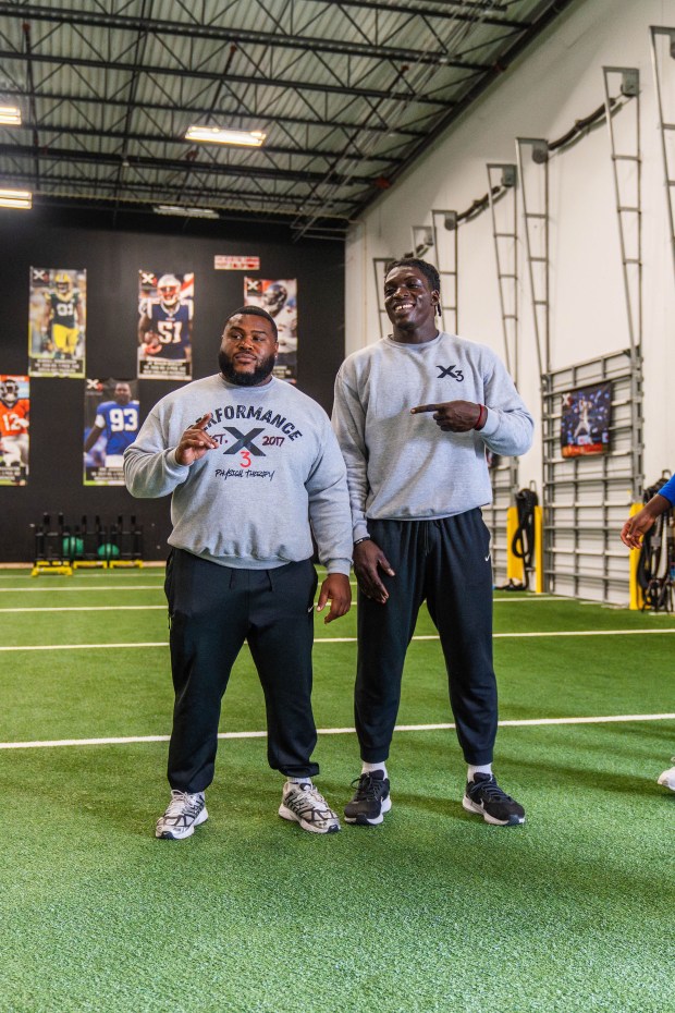 Nigerian prospect Uar Bernard (right), a member of the NFL's International Pathway Program class of 2026, stands with trainer Javon Gopie (left). (Courtesy photo)