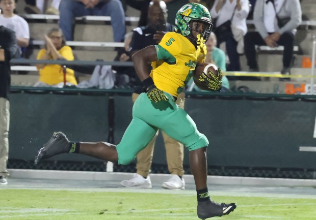 DeLand player Taihj Moore runs for a touchdown during a game against Boone in November. (Stephen M. Dowell/Orlando Sentinel)