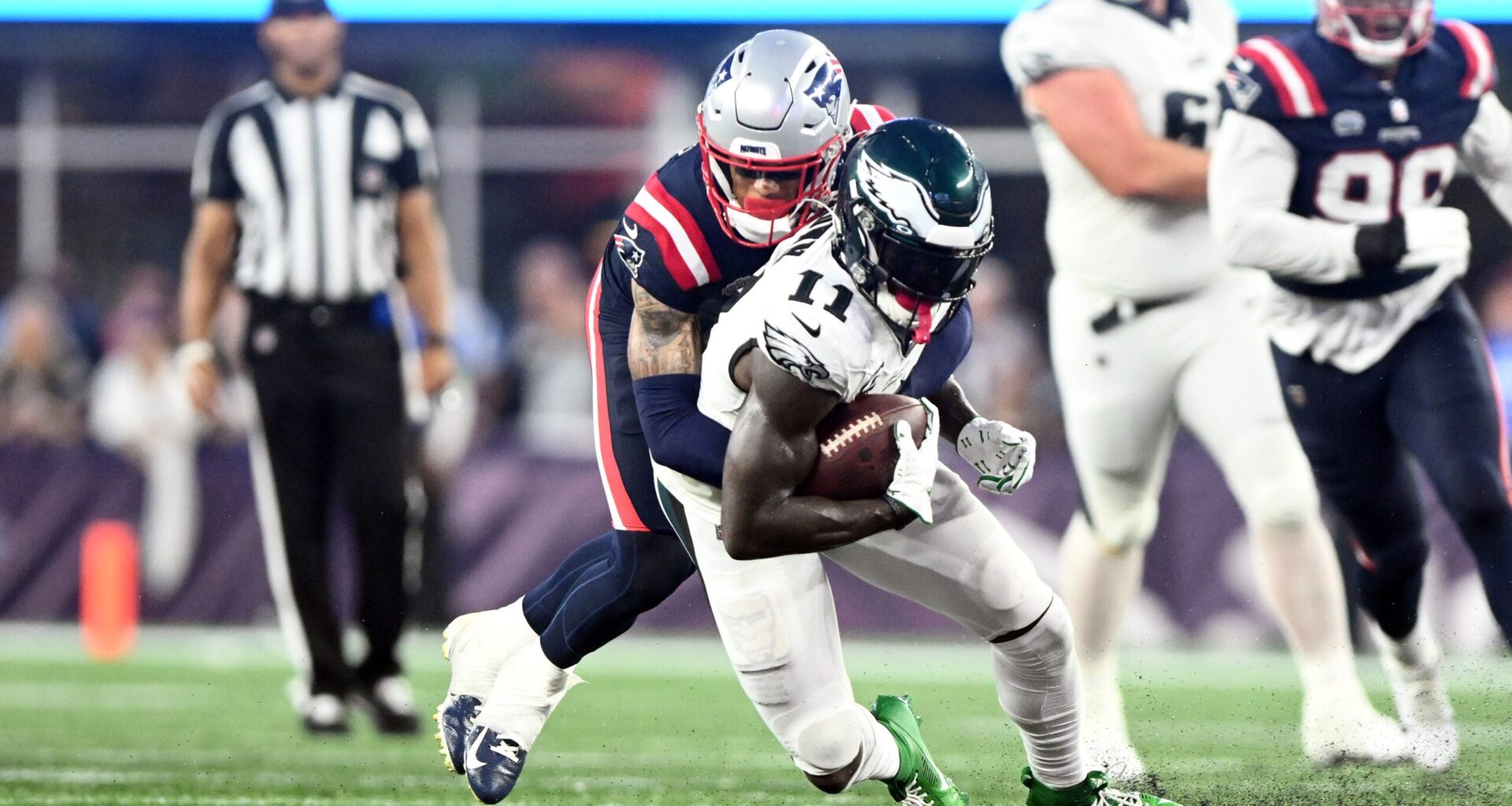 Sep 10, 2023; Foxborough, Massachusetts, USA; Philadelphia Eagles wide receiver A.J. Brown (11) is tackled by New England Patriots cornerback Christian Gonzalez (6) during the second half at Gillette Stadium.