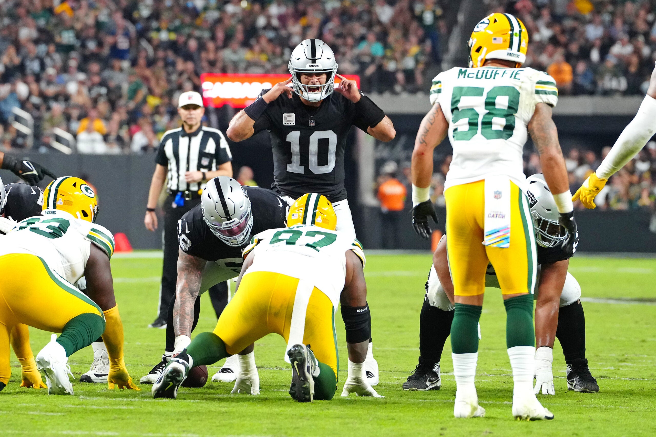 Oct 9, 2023; Paradise, Nevada, USA; Las Vegas Raiders quarterback Jimmy Garoppolo (10) calls a play against the Green Bay Packers during the second quarter at Allegiant Stadium.