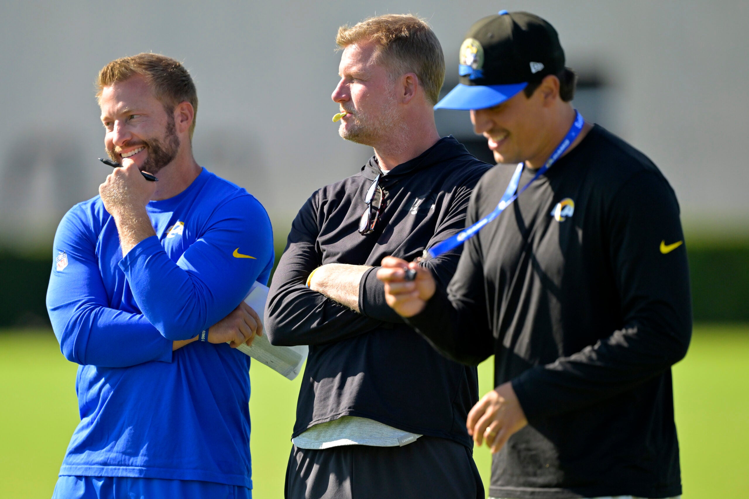 Jul 29, 2024; Los Angeles, CA, USA; Los Angeles Rams head coach Sean McVay, general manager Les Snead and chief of staff Carter Crutchfield talk on the field during training camp at Loyola Marymount University.