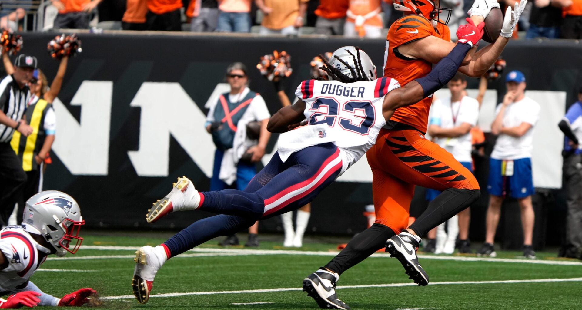 Cincinnati Bengals tight end Tanner Hudson (87) makes a catch as New England Patriots safety Kyle Dugger (23) puts on the pressure, Hudson dropped the ball and Patriots Marcus Jones recovered the ball in the 2nd quarter at Paycor Stadium Sunday, September 8, 2024.