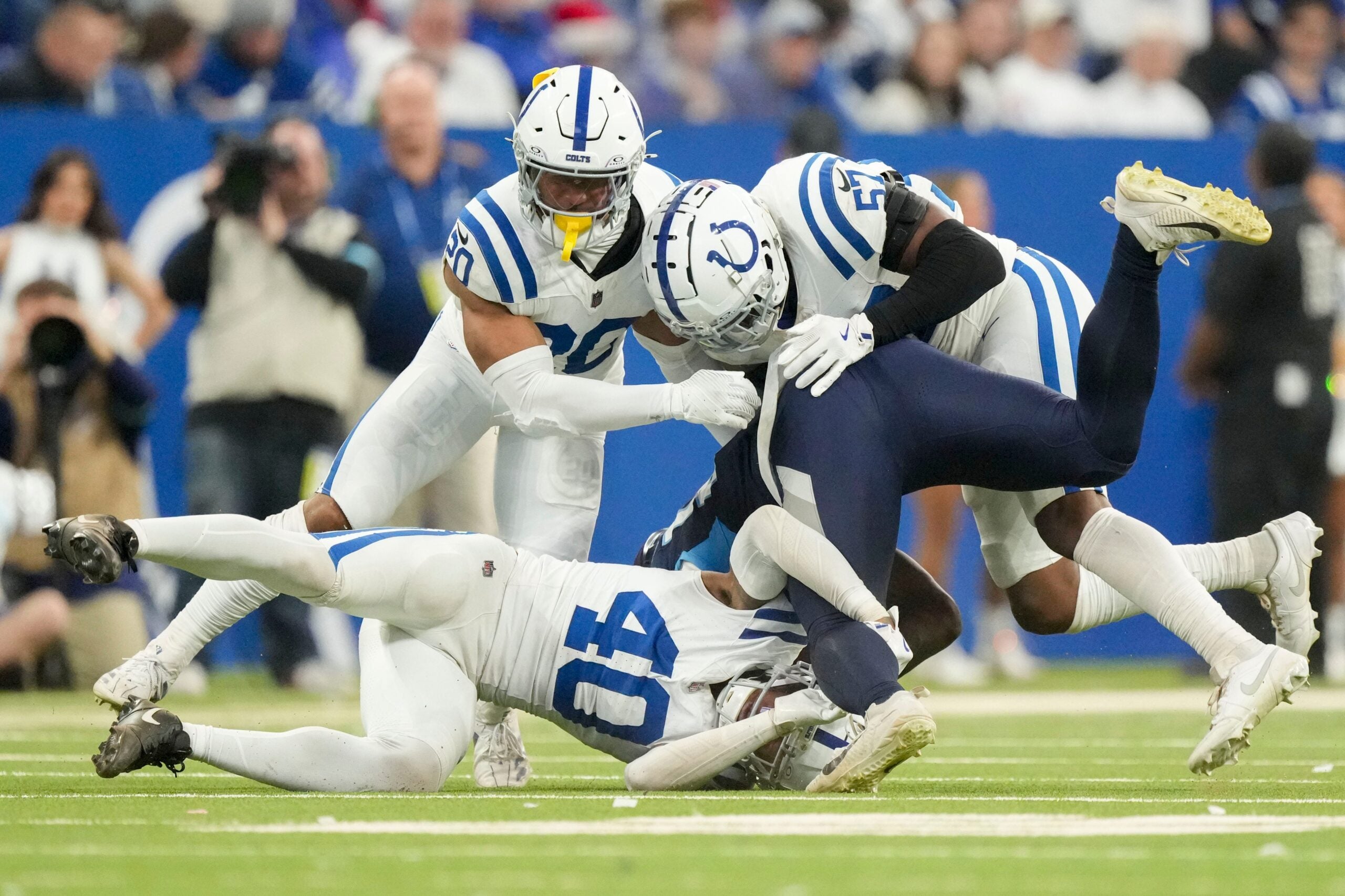 Colts LB Jaylon Carlies, CB Jayon Jones and former safety Nick Cross combine for a tackle