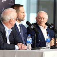 Jan 27, 2025; Frisco, TX, USA; (L to R) Dallas Cowboys CEO Stephen Jones, head coach Brian Schottenheimer and owner Jerry Jones speak to the media at a press conference at the Star.