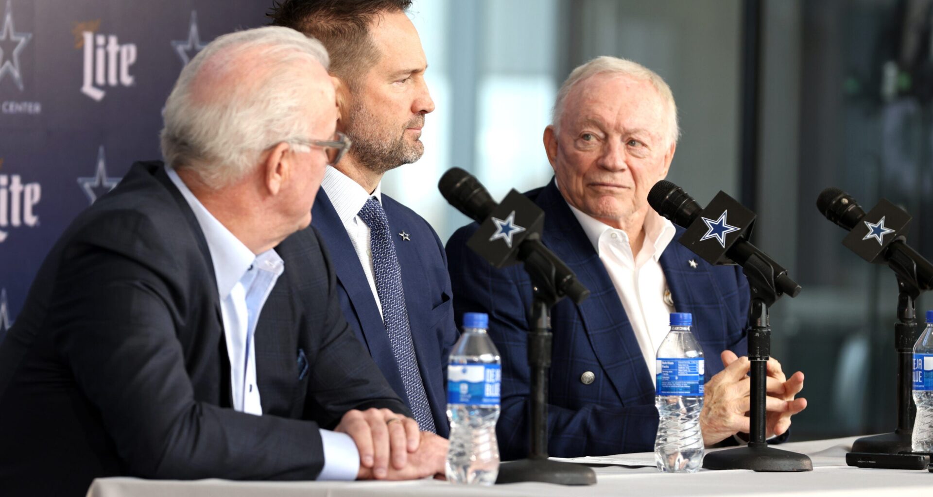 Jan 27, 2025; Frisco, TX, USA; (L to R) Dallas Cowboys CEO Stephen Jones, head coach Brian Schottenheimer and owner Jerry Jones speak to the media at a press conference at the Star.