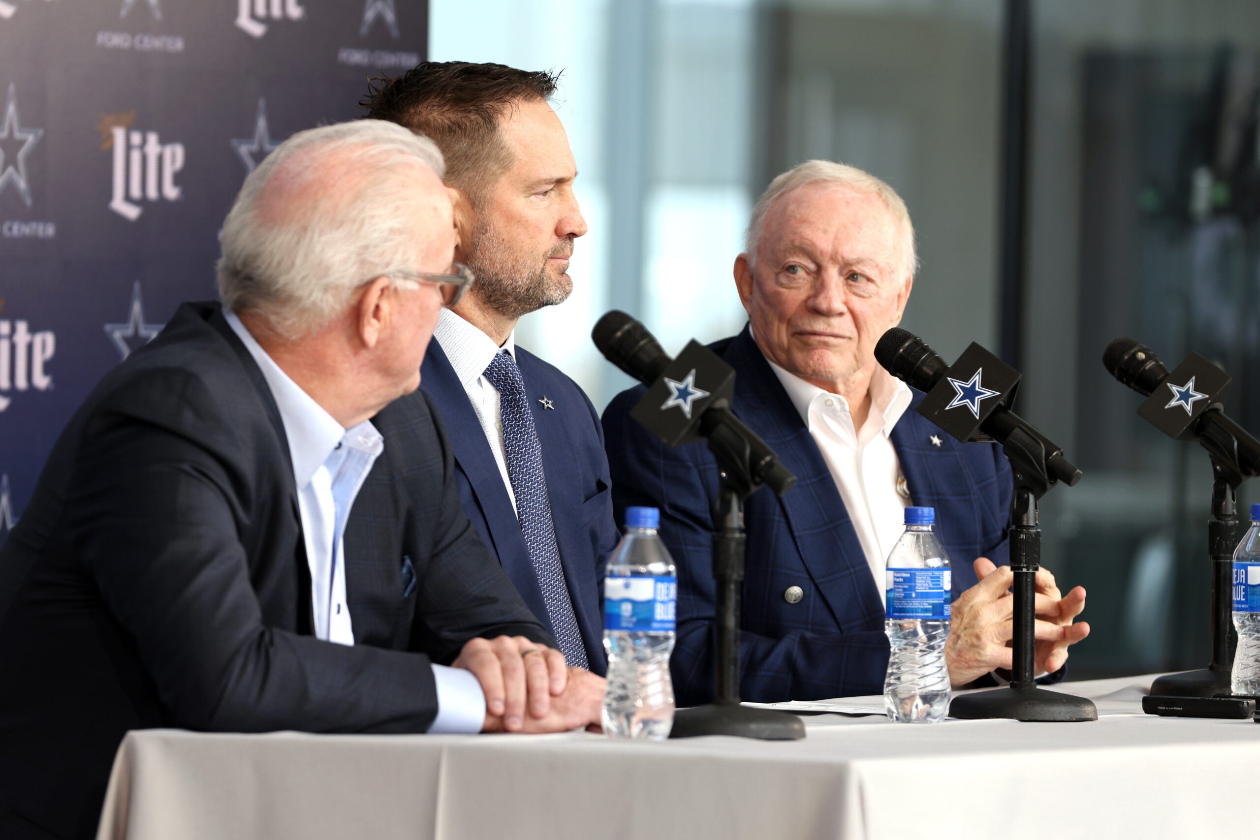 Jan 27, 2025; Frisco, TX, USA; (L to R) Dallas Cowboys CEO Stephen Jones, head coach Brian Schottenheimer and owner Jerry Jones speak to the media at a press conference at the Star.