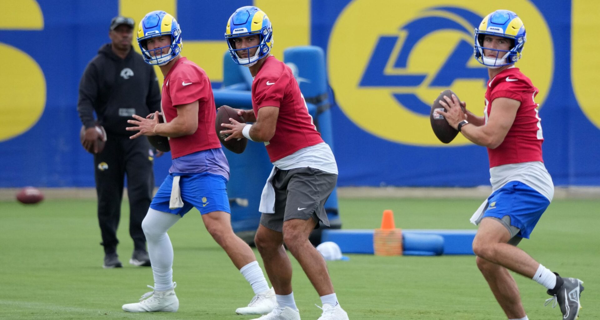 Jun 3, 2025; Woodland Hills, CA, USA; Los Angeles Rams quarterbacks Matthew Stafford (left), Jimmy Garoppolo (center) and Stetson Bennett throw the ball during organized team activities at Rams Practice Facility.