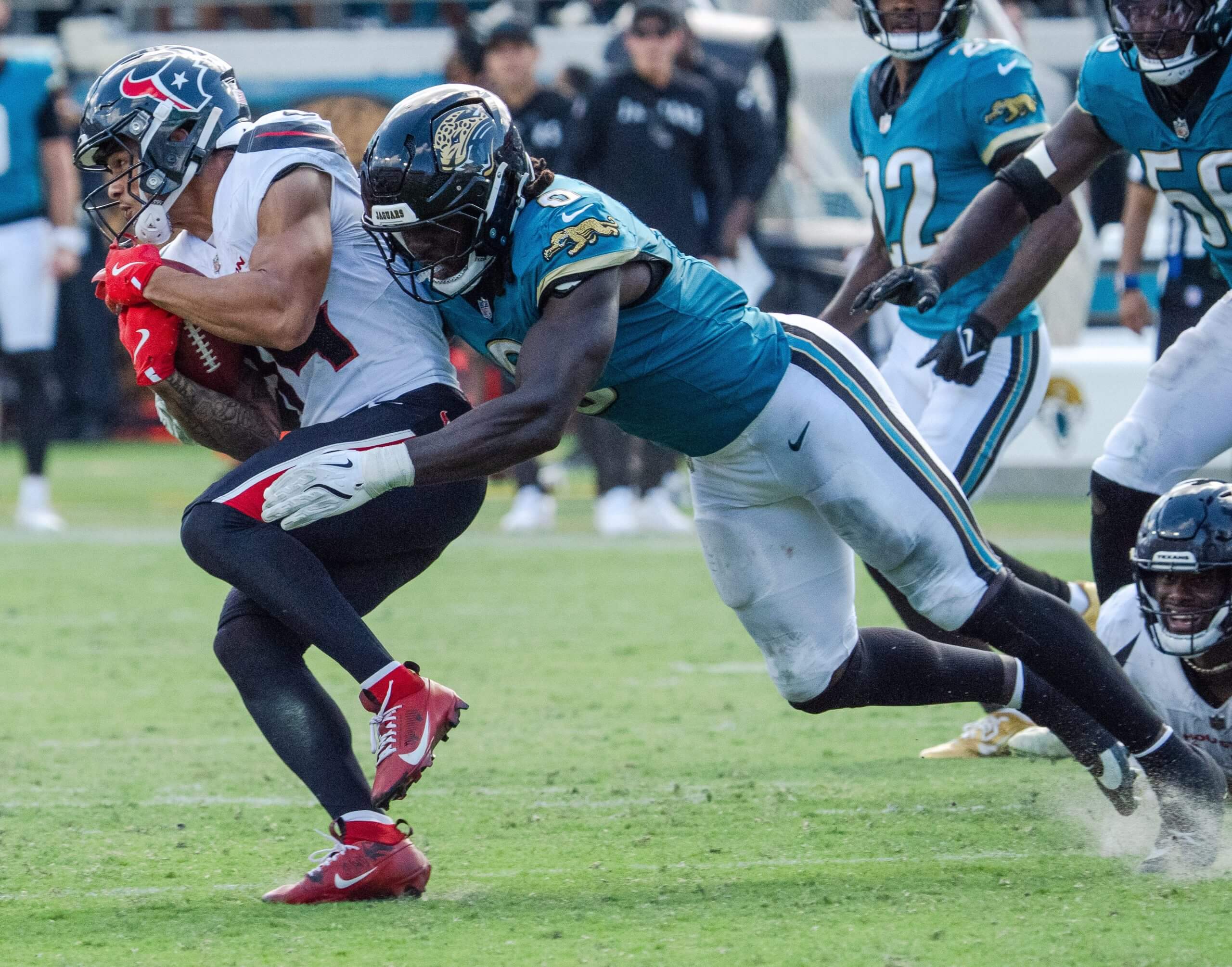 Houston Texans wide receiver Jaylin Noel (14) is tackled by Jacksonville Jaguars linebacker Devin Lloyd (0) during the fourth quarter between the Houston Texans and the Jacksonville Jaguars on Sunday September 21, 2025 at EverBank Stadium in Jacksonville, Fla.
