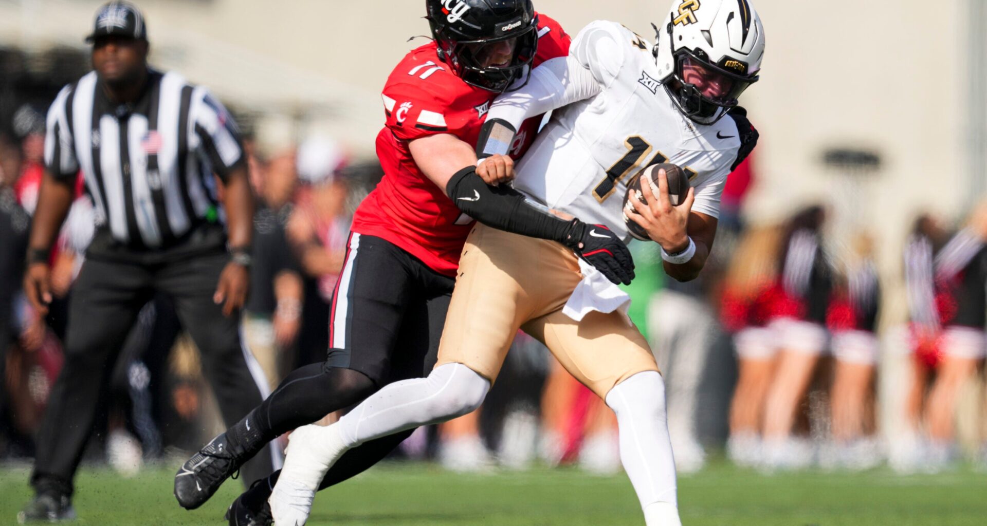 Oct 11, 2025; Cincinnati, Ohio, USA; Cincinnati Bearcats linebacker Jake Golday (11) attempts to tackle UCF Knights quarterback Cam Fancher (14) in the second half at Nippert Stadium.