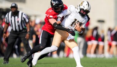 Oct 11, 2025; Cincinnati, Ohio, USA; Cincinnati Bearcats linebacker Jake Golday (11) attempts to tackle UCF Knights quarterback Cam Fancher (14) in the second half at Nippert Stadium.