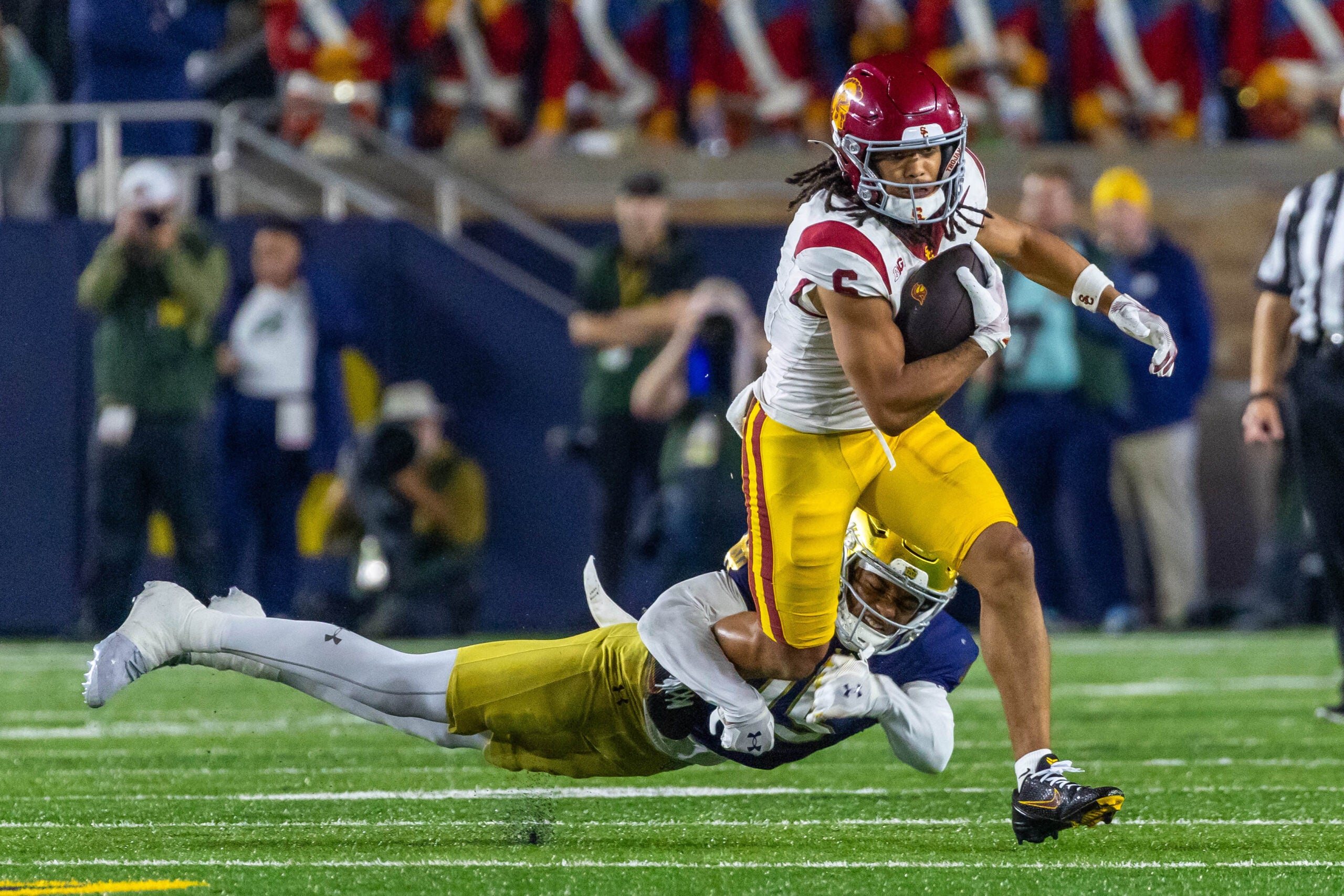 Oct 18, 2025; South Bend, Indiana, USA; Southern California Trojans wide receiver Makai Lemon (6) tries to break a tackle by Notre Dame Fighting Irish cornerback Leonard Moore (15) during the first half at Notre Dame Stadium.