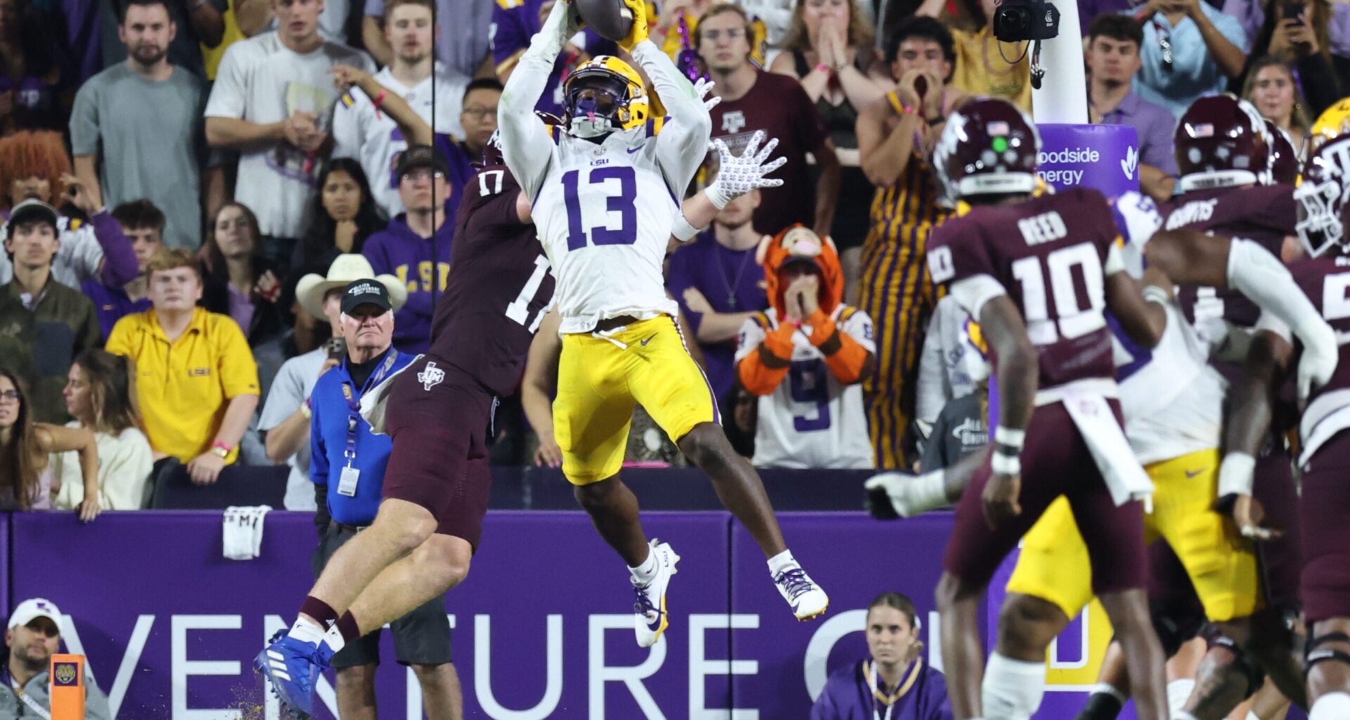 Oct 25, 2025; Baton Rouge, Louisiana, USA; Louisiana State Tigers defensive back A.J. Haulcy (13) makes an interception against Texas A&M Aggies tight end Theo Melin Öhrström (17) during the first half at Tiger Stadium.