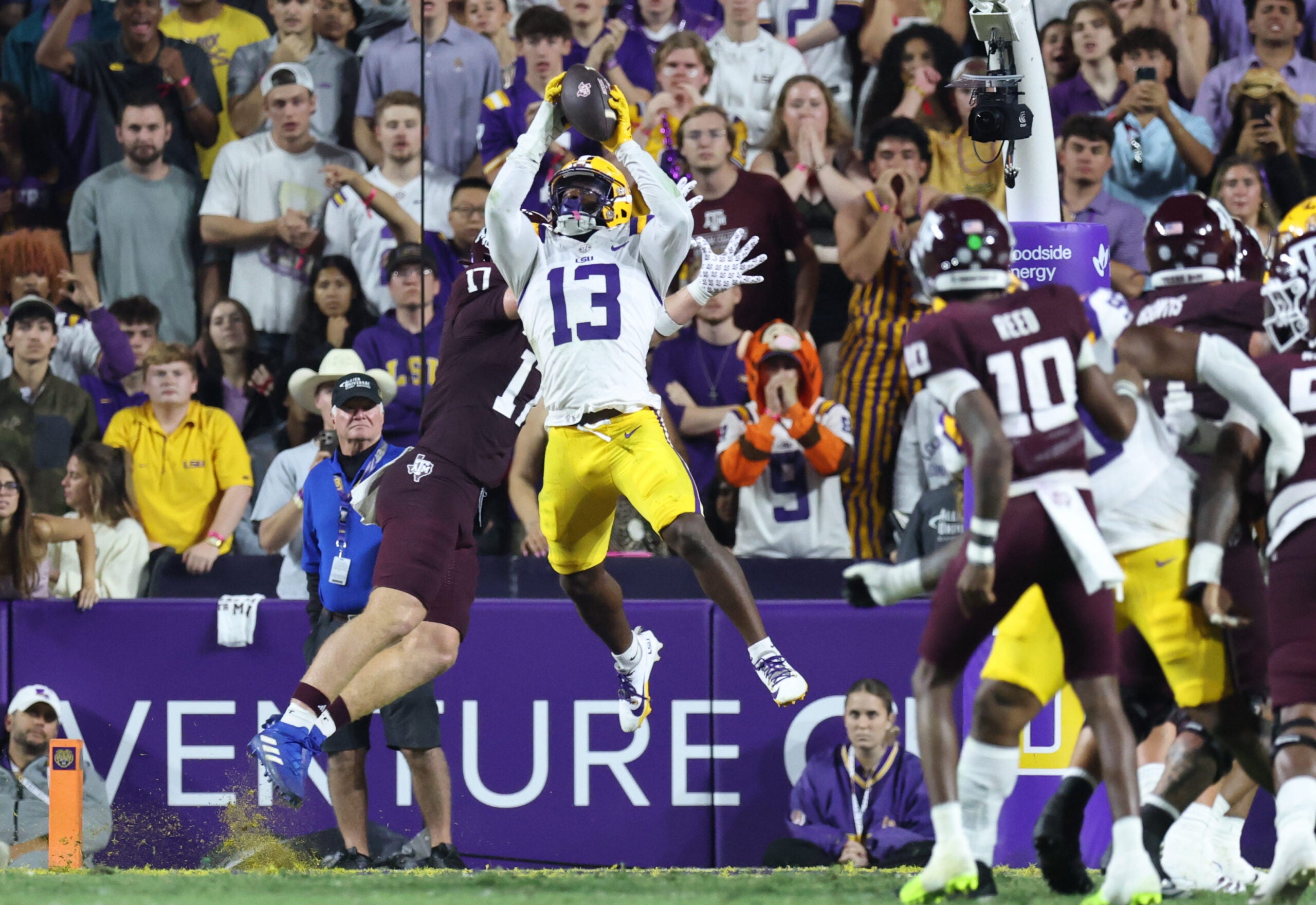 Oct 25, 2025; Baton Rouge, Louisiana, USA; Louisiana State Tigers defensive back A.J. Haulcy (13) makes an interception against Texas A&M Aggies tight end Theo Melin Öhrström (17) during the first half at Tiger Stadium.