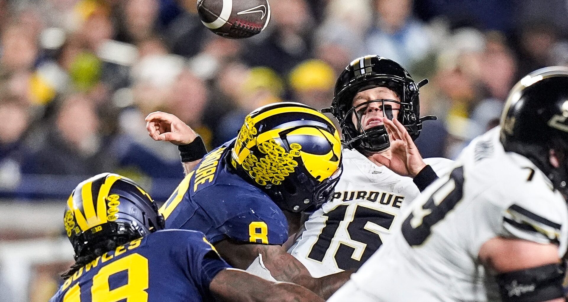 Michigan defensive end Derrick Moore (8) forces Purdue quarterback Ryan Browne (15) to fumble during the first half at Michigan Stadium in Ann Arbor on Saturday, November 1, 2025.