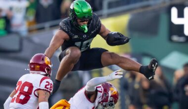 Oregon tight end Kenyon Sadiq hurdles over USC cornerback DeCarlos Nicholson as the Oregon Ducks host the USC Trojans on Nov. 22, 2025, at Autzen Stadium in Eugene, Oregon.