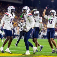 Nov 28, 2025; Tempe, Arizona, USA; Arizona Wildcats defensive back Treydan Stukes (2) celebrates with defensive back Ayden Garnes (9) after an interception against Arizona State Sun Devils in the second half during the 99th Territorial Cup at Mountain America Stadium.
