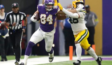 Minnesota Vikings tight end Josh Oliver (84) stiff arms Green Bay Packers linebacker Jamon Johnson (48) on a first down reception during their football game Sunday, January 4, 2026, at U.S. Bank Stadium in Minneapolis, Minnesota.