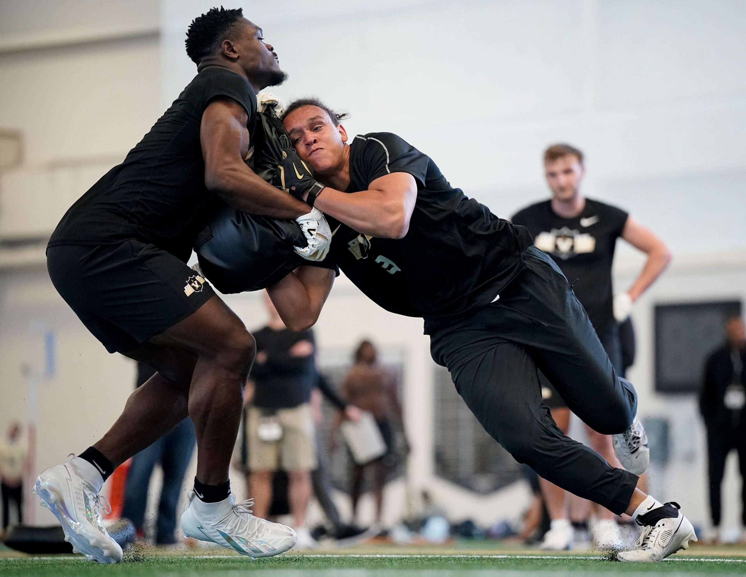 Vanderbilt tight end Emmanuel Adebi, left. and tight end Eli Stowers, right, run drills during football pro day at Vanderbilt University in Nashville, Tenn., Friday, March 20, 2026.
