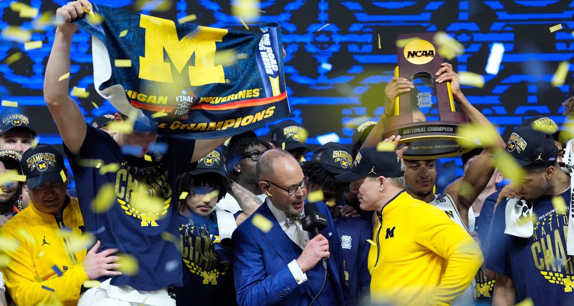 Michigan head coach Dusty May does an interview on stage as the team celebrates beating Connecticut to win the NCAA national championship at Lucas Oil Stadium in Indianapolis on Monday, April 6, 2026.