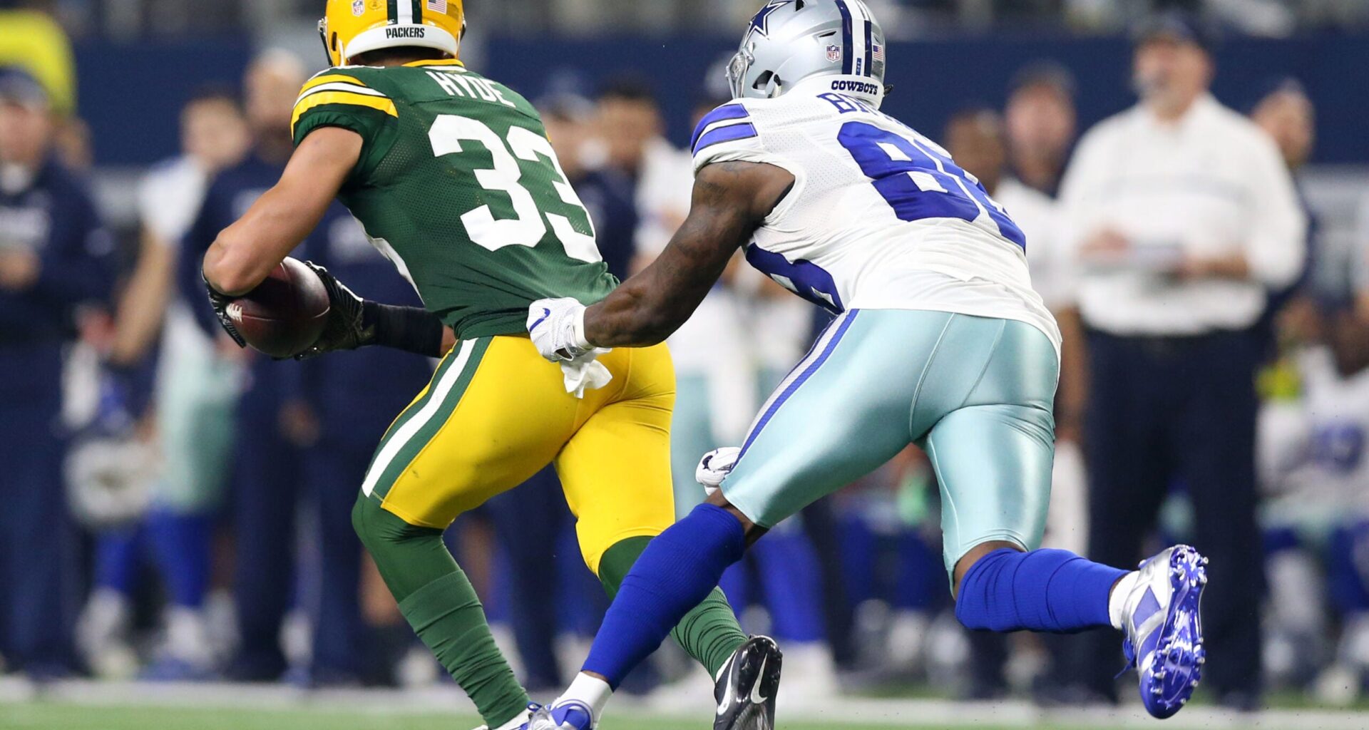 Jan 15, 2017; Arlington, TX, USA; Green Bay Packers strong safety Micah Hyde (33) runs the ball against Dallas Cowboys wide receiver Dez Bryant (88) after an interception during the third quarter in the NFC Divisional playoff game at AT&T Stadium.