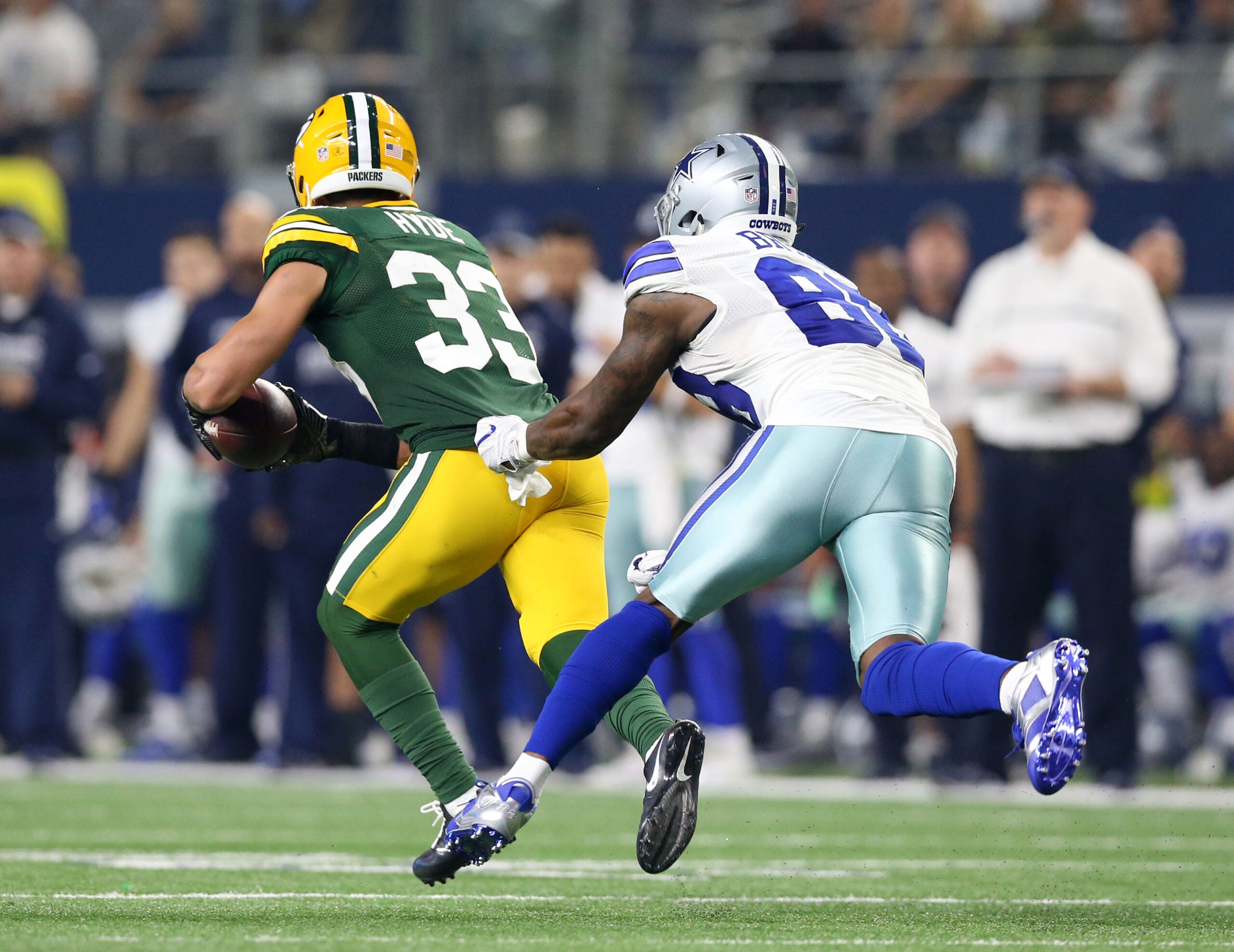 Jan 15, 2017; Arlington, TX, USA; Green Bay Packers strong safety Micah Hyde (33) runs the ball against Dallas Cowboys wide receiver Dez Bryant (88) after an interception during the third quarter in the NFC Divisional playoff game at AT&T Stadium.