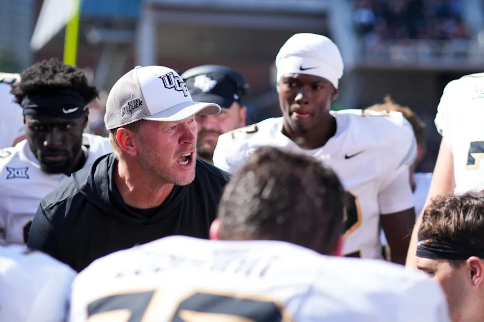 Oct 11, 2025; Cincinnati, Ohio, USA; UCF Knights head coach Scott Frost talks with his team on the sidelines in the game against the Cincinnati Bearcats in the second half at Nippert Stadium. Mandatory Credit: Aaron Doster-Imagn Images