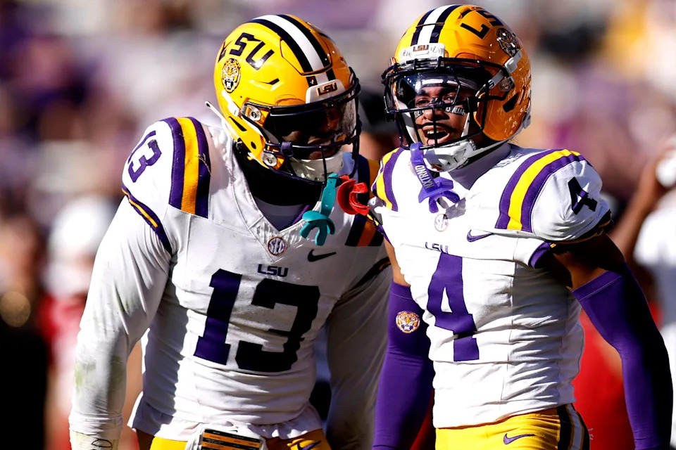 BATON ROUGE, LOUISIANA - NOVEMBER 15: A.J. Haulcy #13 of the LSU Tigers reacts with Mansoor Delane #4 of the LSU Tigers after breaking up a pass during the fourth quarter of an NCAA game against the Arkansas Razorbacks at Tiger Stadium on November 15, 2025 in Baton Rouge, Louisiana. (Photo by Sean Gardner/Getty Images)