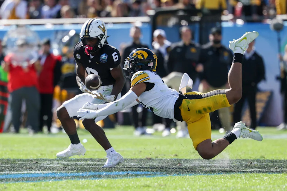 Dec 31, 2025; Tampa, FL, USA; Iowa Hawkeyes defensive back TJ Hall (2) breaks up a pass to Vanderbilt Commodores wide receiver Tre Richardson (6) in the second quarter during the ReliaQuest Bowl at Raymond James Stadium. Mandatory Credit: Nathan Ray Seebeck-Imagn Images