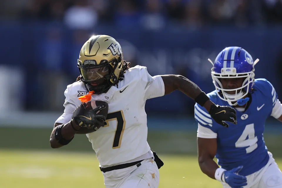 Nov 29, 2025; Provo, Utah, USA; UCF Knights wide receiver Duane Thomas Jr. (7) runs after a catch against BYU Cougars cornerback Mory Bamba (4) during the first quarter at LaVell Edwards Stadium. Mandatory Credit: Rob Gray-Imagn Images