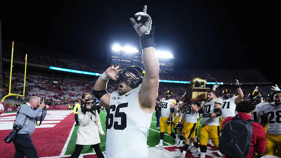 Iowa Hawkeyes offensive lineman Logan Jones (65) celebrates a win after the game 