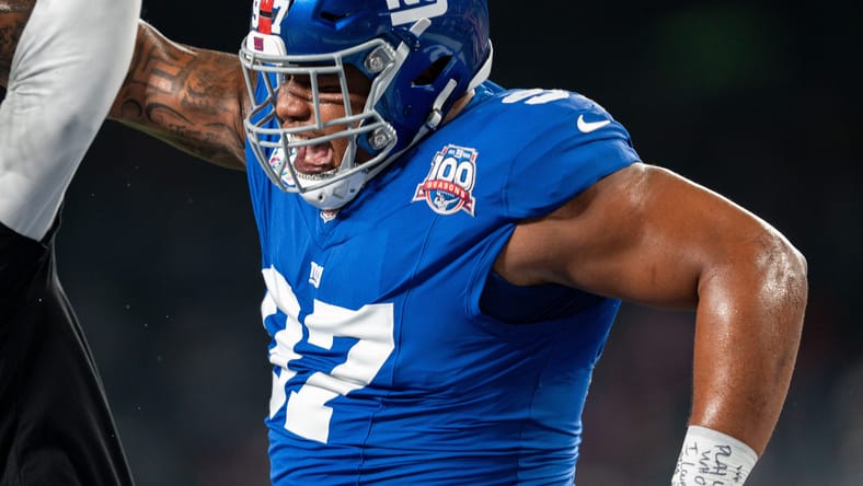 Dexter Lawrence celebrates with a coach during pregame at MetLife Stadium