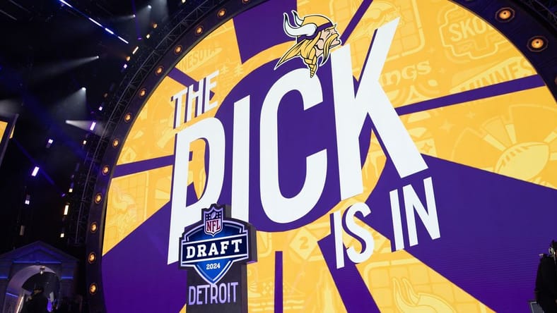 Jordan Addison stands on stage after being drafted by the Vikings in the first round.