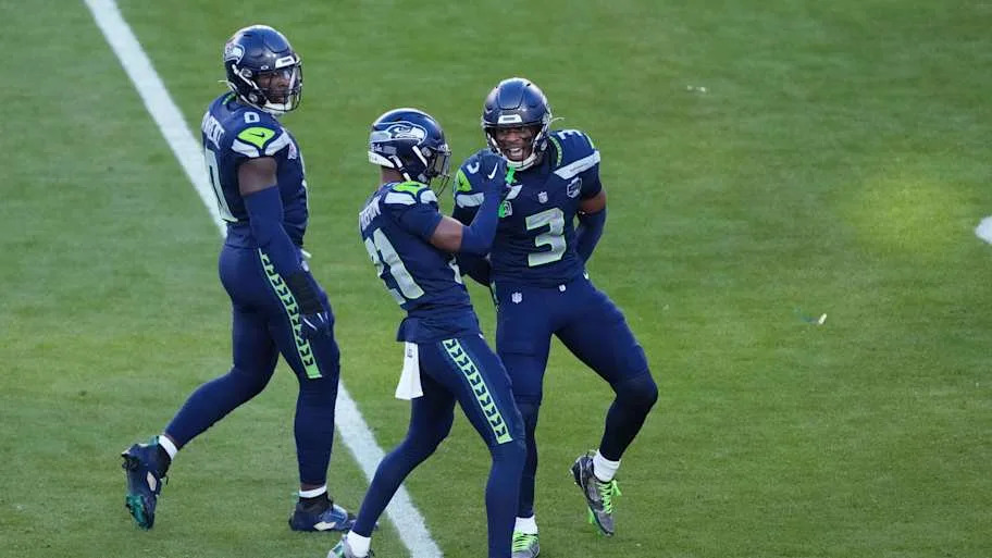 Seattle Seahawks cornerback Devon Witherspoon (21) and Seattle Seahawks safety Nick Emmanwori (3) celebrate a stop