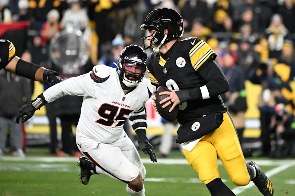 Jan 12, 2026; Pittsburgh, PA, USA; Pittsburgh Steelers quarterback Aaron Rodgers (8) scrambles from Houston Texans defensive end Derek Barnett (95) during the first half of an AFC Wild Card Round game at Acrisure Stadium. Mandatory Credit: Barry Reeger-Imagn Images