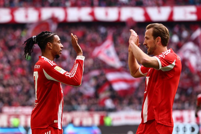 epa12838979 Michael Olise of Munich (L) celebrates with teammate Harry Kane after scoring the 1-0 opening goal during the German Bundesliga soccer match between FC Bayern Munich against 1. FC Union Berlin, in Munich, Germany, 21 March 2026. EPA/ANNA SZILAGYI CONDITIONS - ATTENTION: The DFL regulations prohibit any use of photographs as image sequences and/or quasi-video.