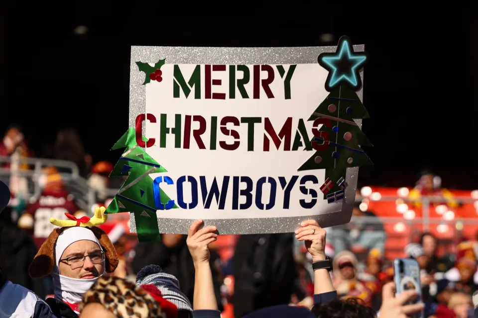 A general view as a fan holds a sign reading Merry Christmas Cowboys before the NFL game against the Washington Commanders at Northwest Stadium on December 25, 2025 in Landover, Maryland. 