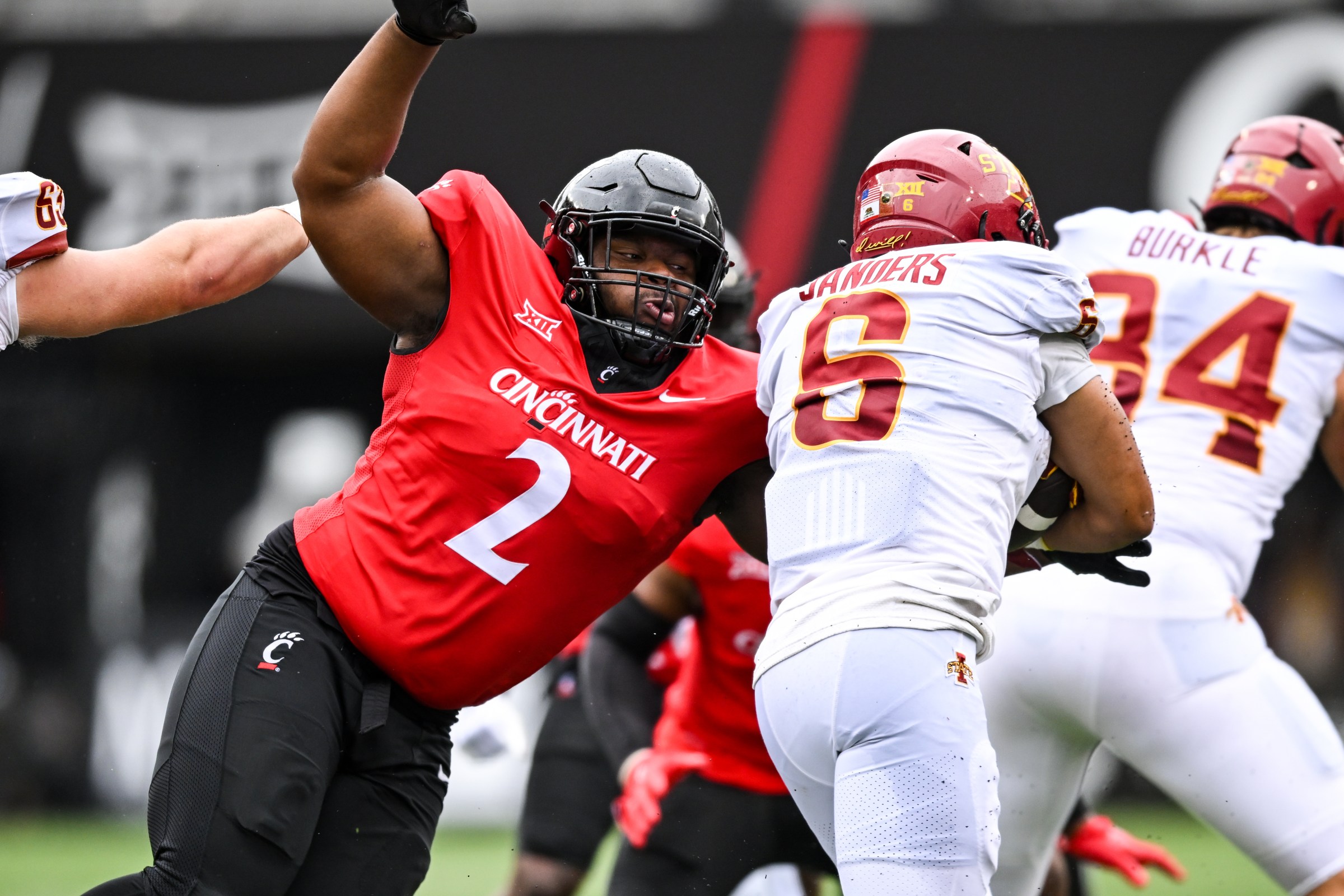 CINCINNATI, OH - OCTOBER 14: Cincinnati DL Dontay Corleone tackles Iowa State RB Eli Sanders (6) during a college football game between the Iowa State Cyclones and Cincinnati Bearcats on October 14, 2023 at Nippert Stadium in Cincinnati, OH. (Photo by James Black/Icon Sportswire via Getty Images)