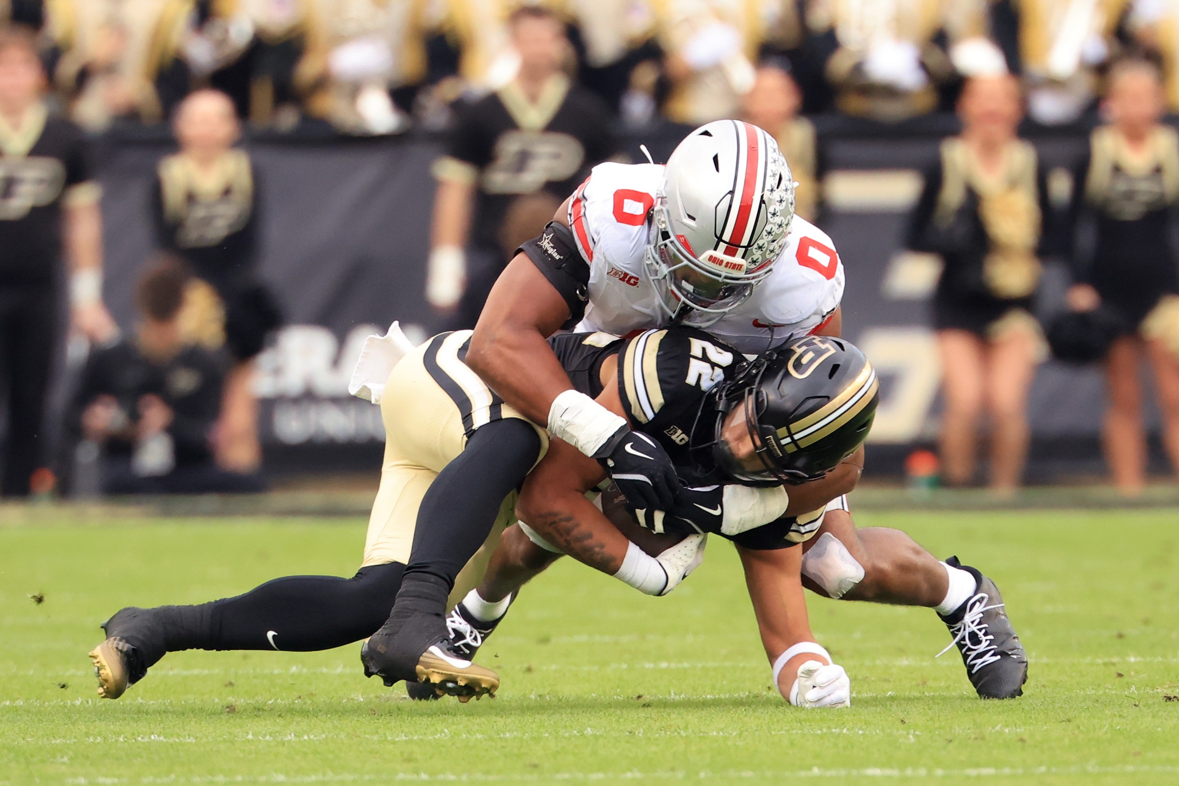 WEST LAFAYETTE, INDIANA - NOVEMBER 08: Sonny Styles #0 of the Ohio State Buckeyes tackles Antonio Harris #22 of the Purdue Boilermakers during the first half at Ross-Ade Stadium on November 08, 2025 in West Lafayette, Indiana. (Photo by Justin Casterline/Getty Images)