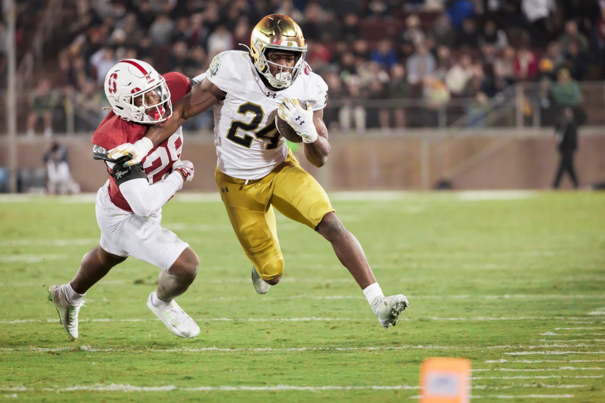 PALO ALTO, CA - NOVEMBER 29: Jadarian Price #24 of the Notre Dame Fighting Irish carries the ball during a college football game against the Stanford Cardinal on November 29, 2025 at Stanford Stadium in Palo Alto, California; defending is Darrius Davis #29 of Stanford. (Photo by David Madison/Getty Images)
